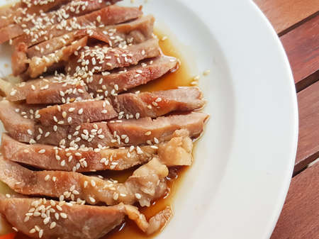 Selective focus pork teriyaki sauce served with vegetable on wood backgroundの写真素材