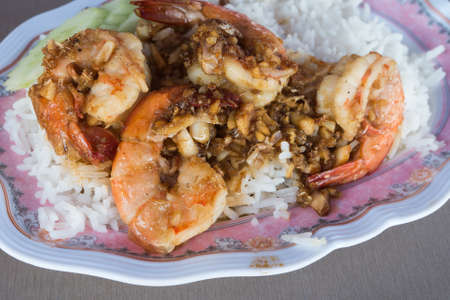 Thai food style:Fried shrimp with garlic and black pepper, serve with cooked riceの写真素材