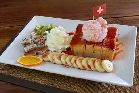 Strawberry honey Toast bread topped with ice cream, stawberry sevred with fruit and whipped cream,process colorの写真素材