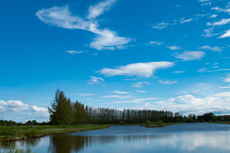 Beautiful clouds over the river in summerの写真素材