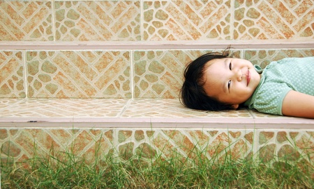 laying down girl on a stairwayの写真素材
