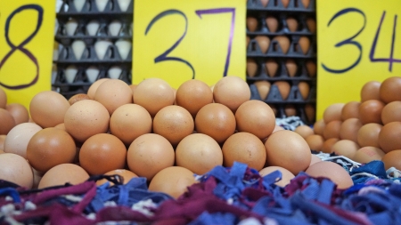 background of fresh eggs for sale at a marketの写真素材