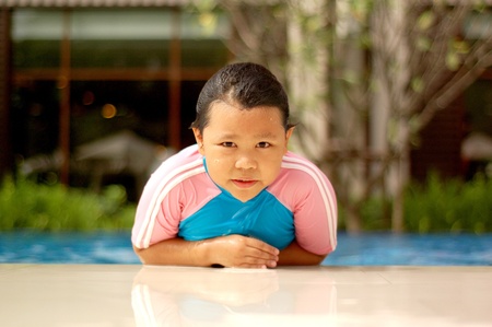 girl child in blue water of the swimming poolの写真素材