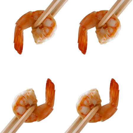 Cooked unshelled tiger shrimp in chopsticks, isolated on whiteの写真素材
