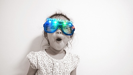 portrait of girl with happy new year eyeglassesの写真素材
