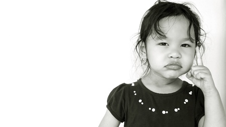 Portrait of cute little girl with wondering faceの写真素材