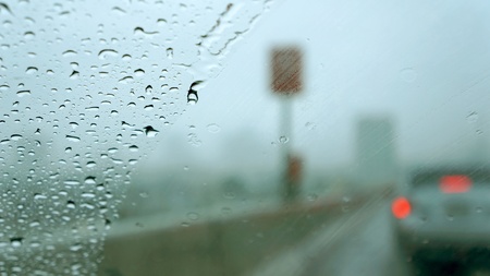 rainy window in road trafficの写真素材
