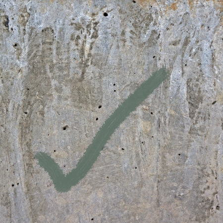 checkmark symbol on cement backgroundの写真素材