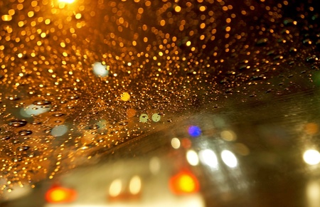 Rain on car front window at nightの写真素材