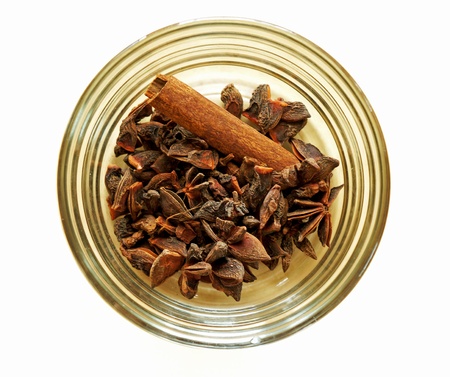 Cloves, anise and cinnamon in glass bowlの写真素材