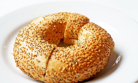 freshly baked bagel on a white plate on a white backgroundの写真素材