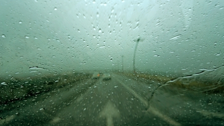 Driving in rain with street arrow signの写真素材