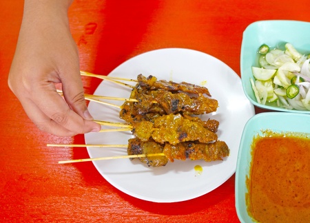 beef barbecue sticks with hand pick itの写真素材