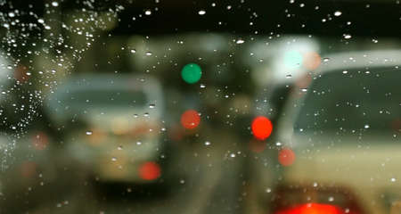 water drops on window glass viewed through a car windscreenの写真素材