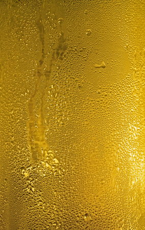 Close-up of condensation drops on a glass of cold lagerの写真素材