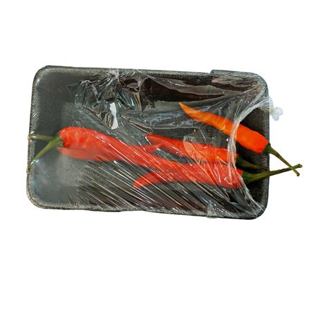 Hot chili peppers in retail pack isolated on whiteの写真素材
