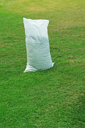 fertilizer in bag on green grassの写真素材