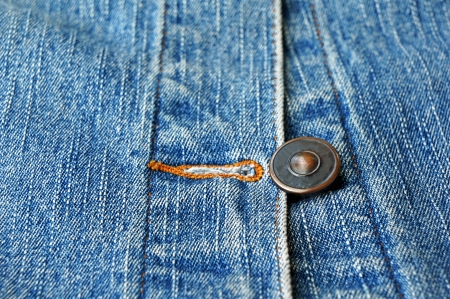 metal button on jeans close upの写真素材
