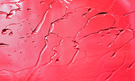 Water drops on abstract red surface