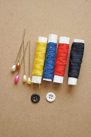Sewing accessories  thimble, thread on a wooden tableの写真素材