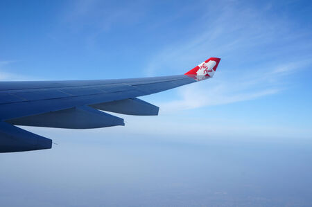 OSAKA JAPAN MARCH 11 2014:AirAsia plane flying in sky over Kansai Airport, Osaka on 11 Mar...