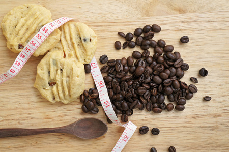 Low fat cookies on wooden table with coffee beansの写真素材