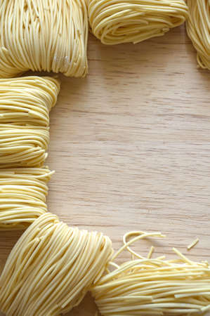 Noodle frame design on wooden backgroundの写真素材