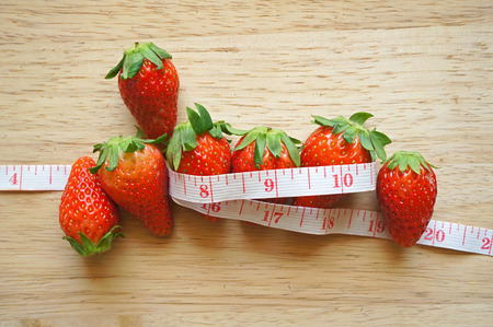 Strawberries with measure tape, healthy life conceptの写真素材