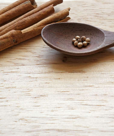 Peppercorn with cinnamon on wooden tableの写真素材