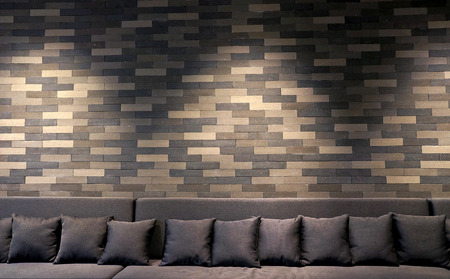sofa in brick room and lighting on wall