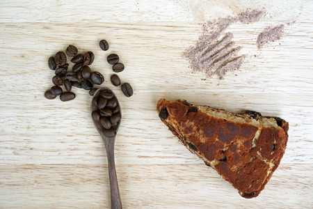 Cake, coffee beans on wooden plateの写真素材
