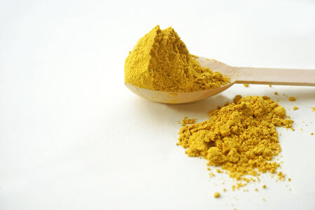turmeric over the spoon on white の写真素材