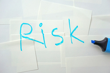 written a word  risk  on white small papersの写真素材