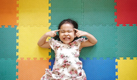Little girl smile on colorful rubber floorの写真素材