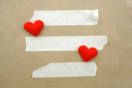 Brown paper, white tape and heart shape for backgroundの写真素材