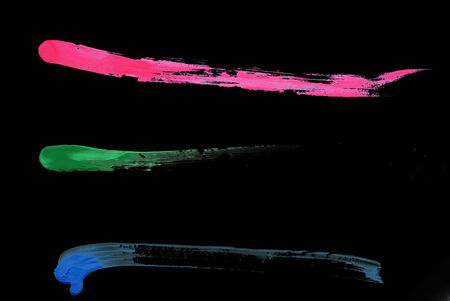 Colorful brush strokes on black backgroundの写真素材