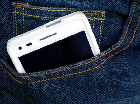 Close up of smart phone in pocket jeansの写真素材