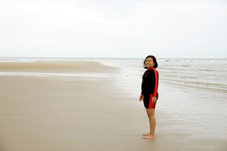 Little girl standing by the seaの写真素材
