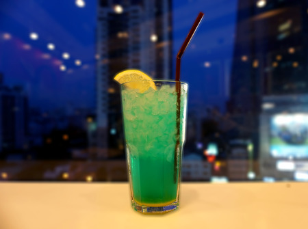 Cocktail glasses against city viewの写真素材