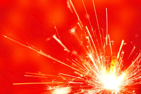 sparkler fire on red backgroundの写真素材