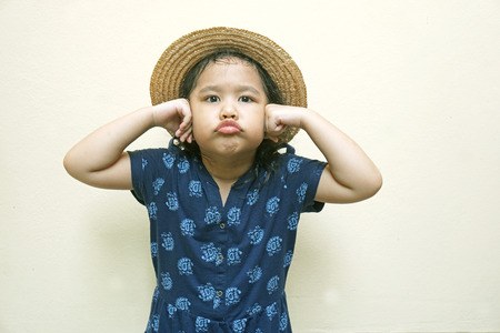 little girl holding her hands over earsの写真素材