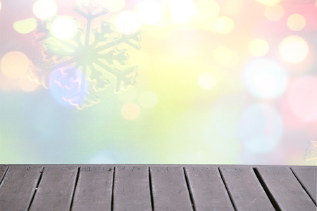 Christmas winter background with wooden table and blurred bokehの写真素材