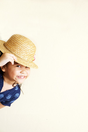 Little girl hiding and smilingの写真素材