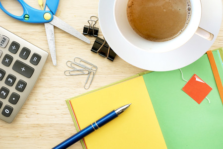 Office table with coffee cup, suppliesの写真素材
