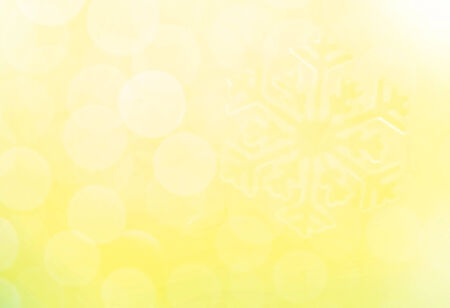 Snowflake on glitter yellow backgroundの写真素材
