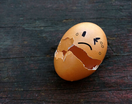 Emotion on eggshell on wooden tableの写真素材