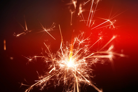 sparkler fire on red backgroundの写真素材