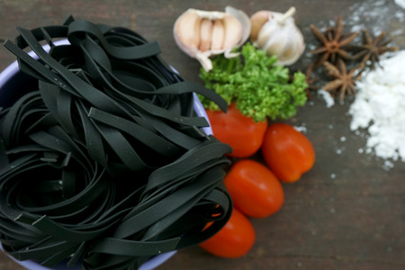 Pasta with ingredients like flour, tomato, garlic and pepperの写真素材