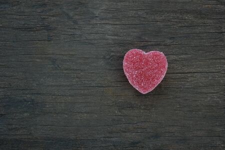 Candy in shape of hearts on wooden background. Top view.の写真素材