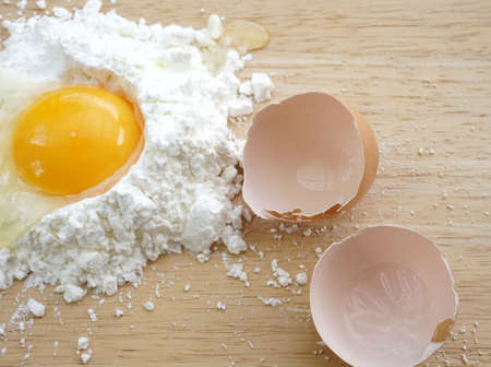 white flour and eggs on wooden backgroundの写真素材